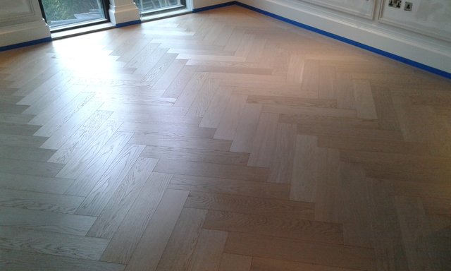 Sanded and sealed parquet flooring.